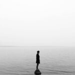 Man in Black Jacket Standing on the Seashore